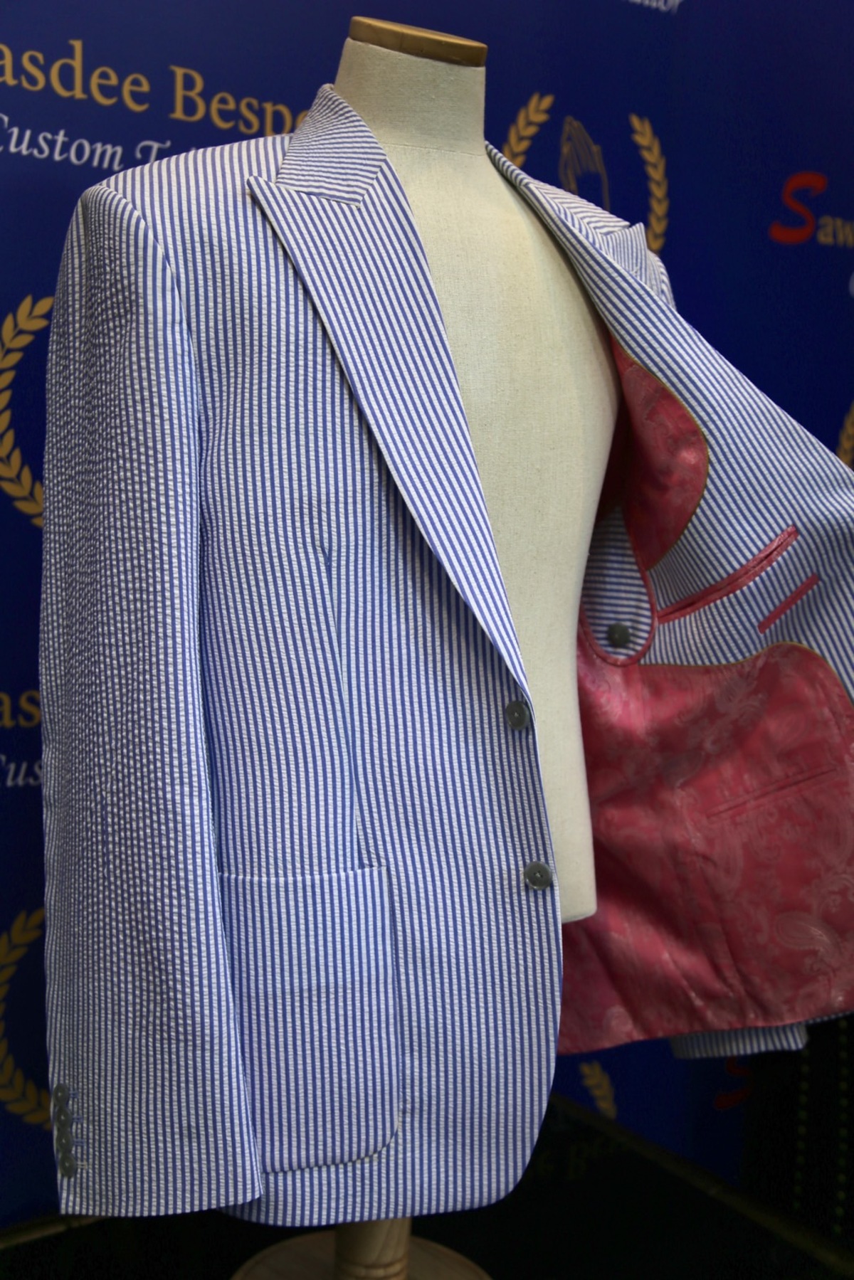 Master tailor hand stitching a suit jacket